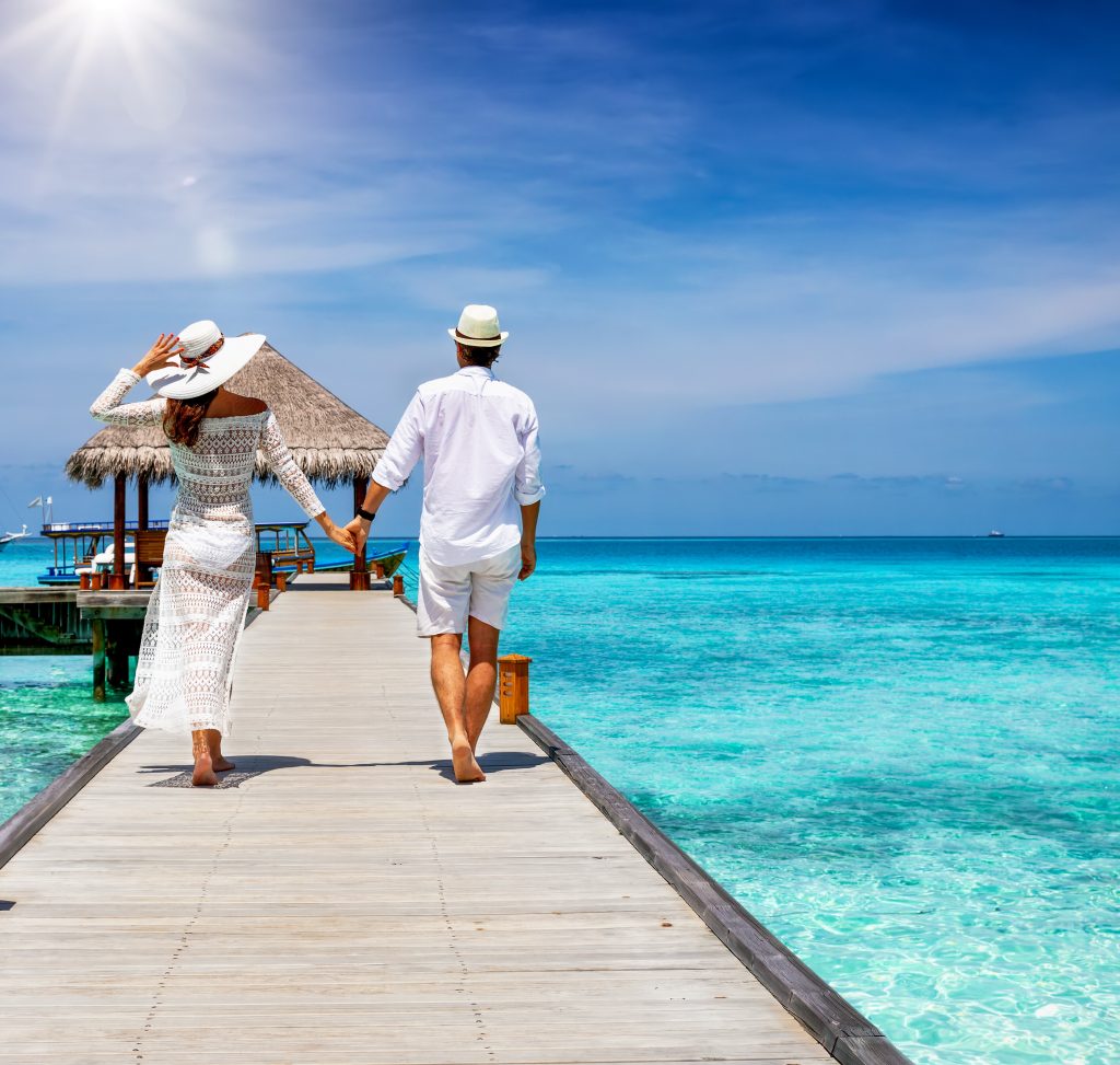 Couple on vacation, walking on the dock, about to get on a boat