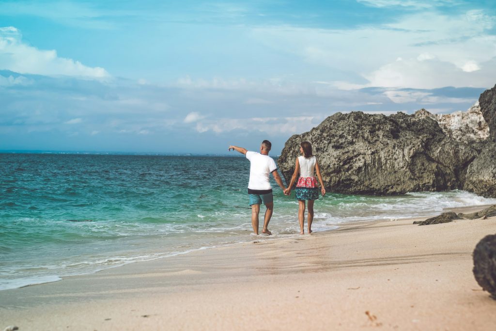 Couple Holding Hands at Bali Beach Couple Holding Hands at Bali Beach