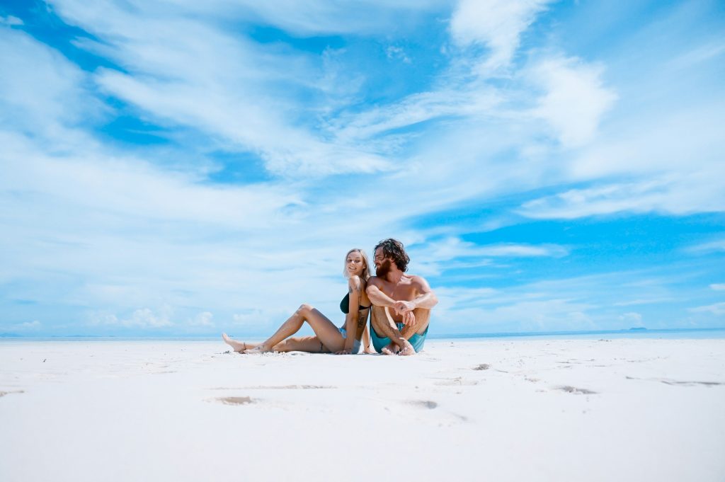 Couple Sitting at the Beach Couple Sitting at the Beach